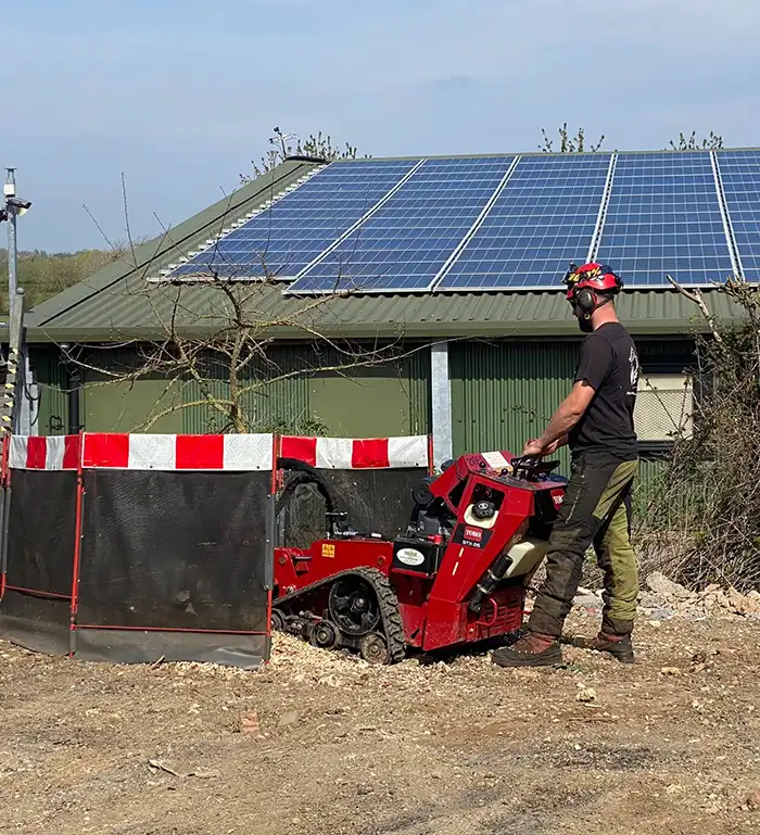 Man stump grinding around commercial offices